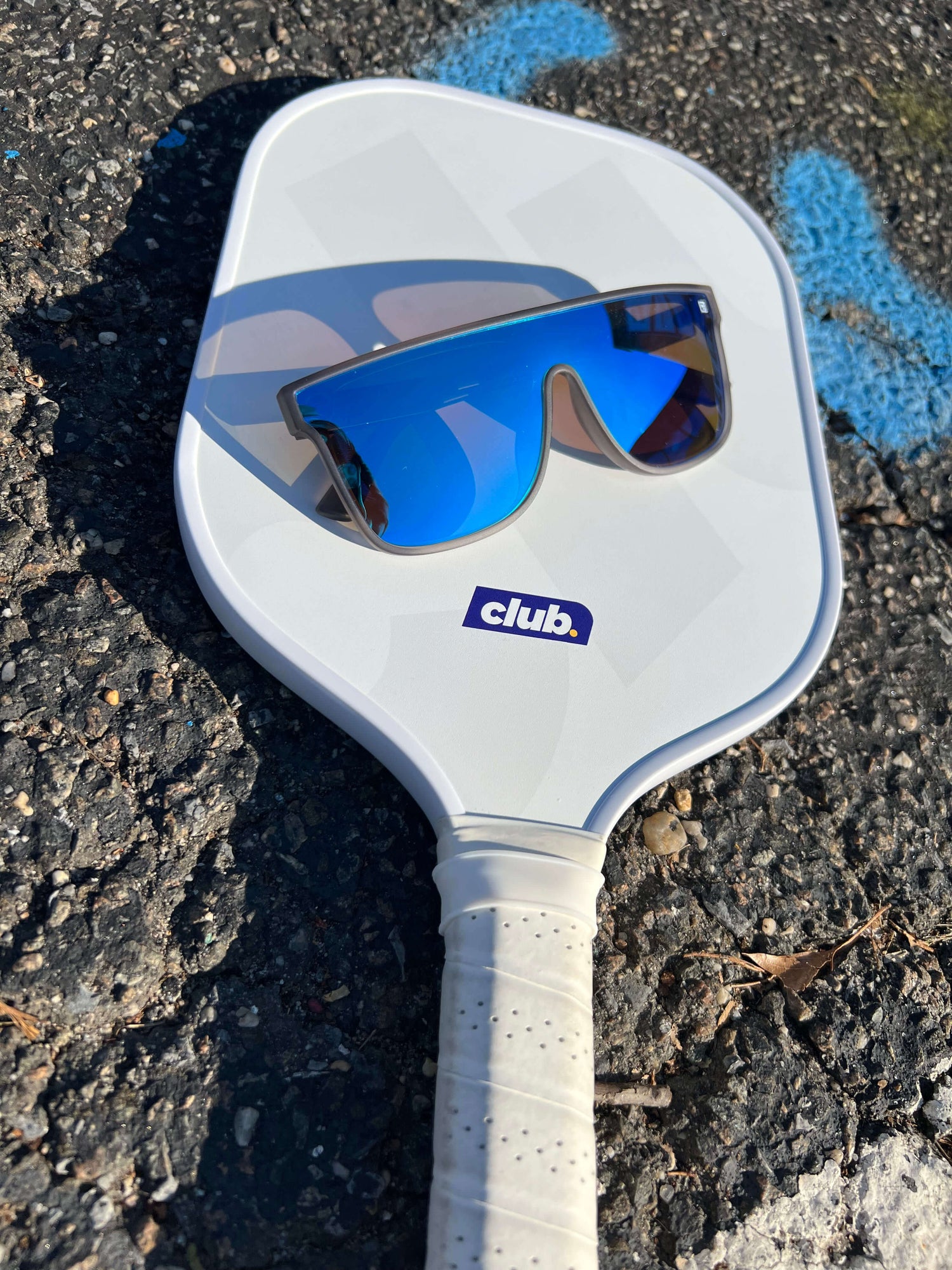A close-up of a pair of sunglasses with polarized lenses, suitable for use during outdoor activities such as pickleball.